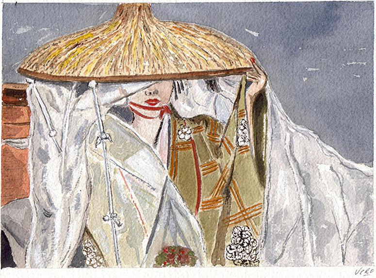 Mujer sujetando con la mano izquierda su sombrero vietnamita.