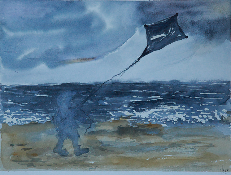 Niño con cometa en la playa.